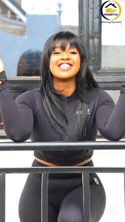 Azziad Nasenya in vibrant attire, smiling confidently